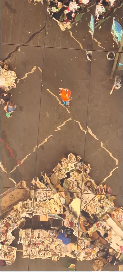 The flea market Els Encants with the reflective roof - the orange person in the middle is the author