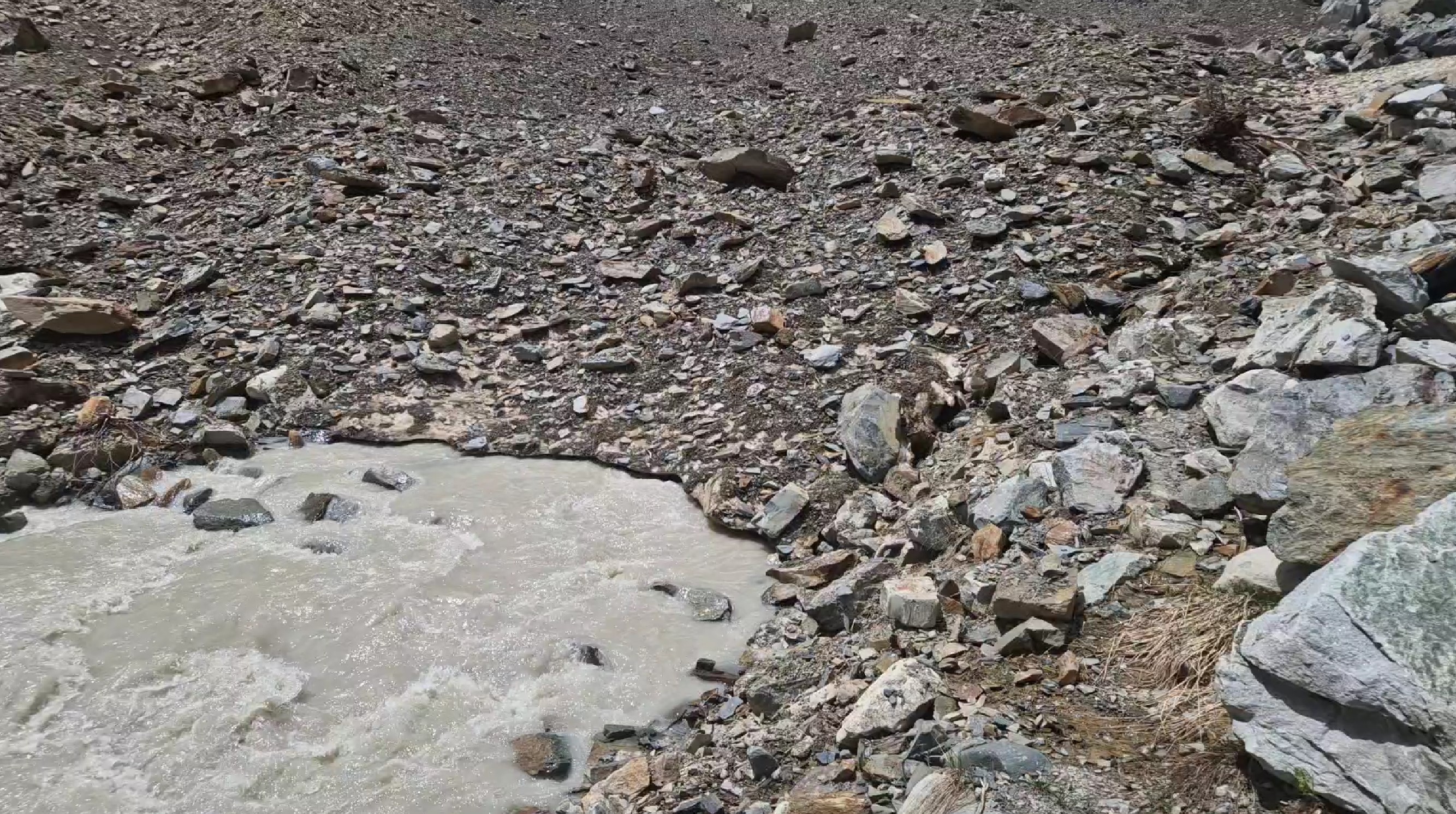 Water flowing from beneath the rocck